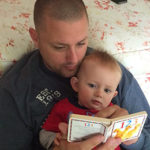 Dad reading to son