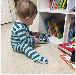 Infant with bookshelf