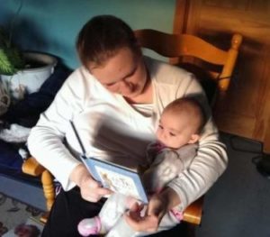 Mom reading to infant
